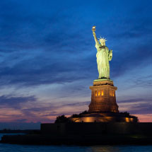 statue of liberty at night with spotlight