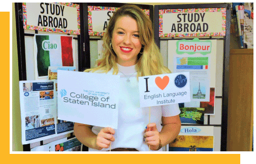 A young woman holding a College of Staten Island sign